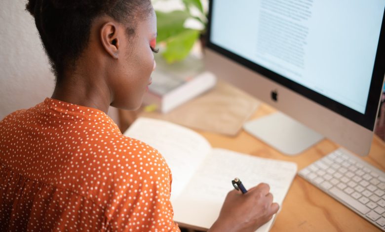 woman writing on her notebook