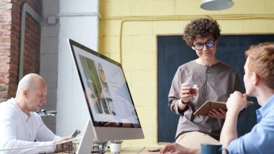 man in blue collared top using imac indoors