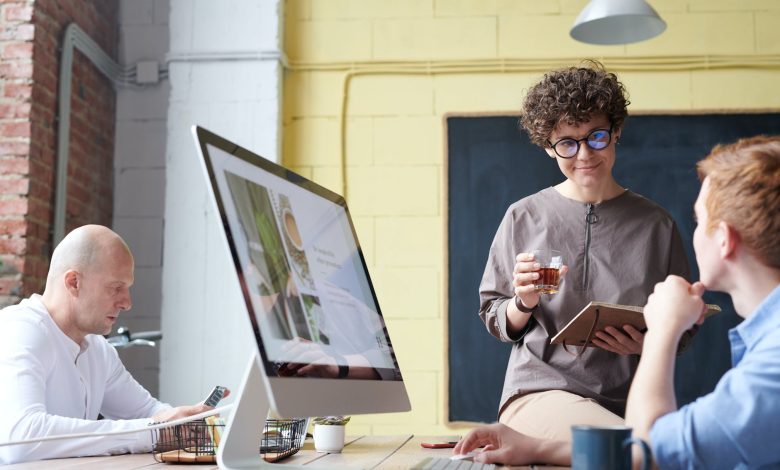 man in blue collared top using imac indoors